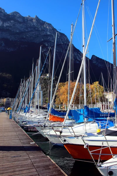 Yachts, standing in the parking lot at the dock of Lake Garda.