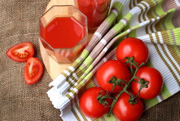 Tomaat SAP pour in glazen en rijpe tomaten. — Stockfoto
