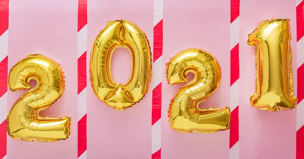 2021 gold balloons with warning tape on pink background for keeping social distance during covid 19 coronavirus quarantine. Christmas, Happy New year eve lockdown invitation. Social distancing. — Stock Photo, Image