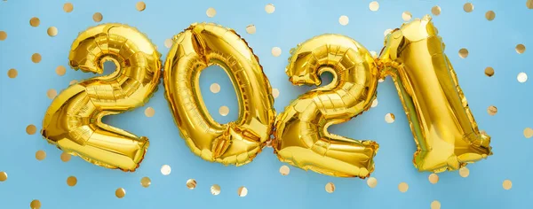 2021 golden balloon text on blue background with confetti . Happy New year eve invitation with Christmas gold foil balloons 2021. Flat lay long web banner