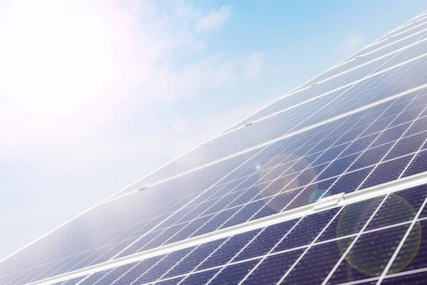 Solar panels on house roof against blue sky. Solar energy power. Sun electricity technology. Stock photo solar panels as a background with sunbeams in sunny day