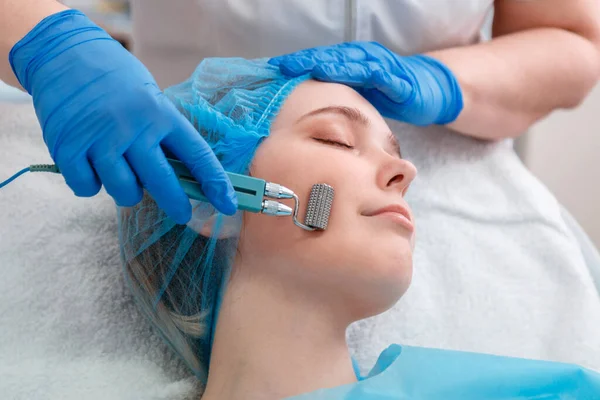 Mesotherapy cosmetology procedures. Doctor cosmetologist doing mesotherapy Cosmetology services to woman with mesoscooter. Hardware cosmetology of skin care health.