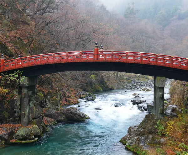Красный мост через бурную горную реку.