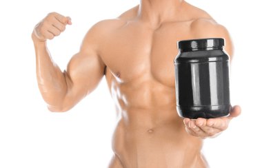 Bodybuilding and Sports theme: handsome strong bodybuilder holding a plastic jar with a dry protein and showing gesture isolated on white background in studio