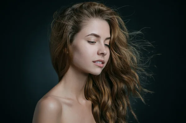 Dramatický portrét dívky téma: portrét krásné dívky s létáním vlasy ve větru na pozadí ve studiu — Stock fotografie
