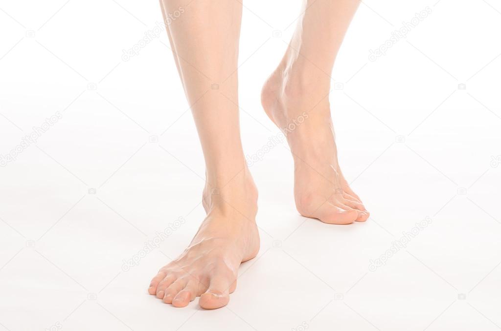 Pedicure and foot care topic: the naked man's legs isolated on white background in studio