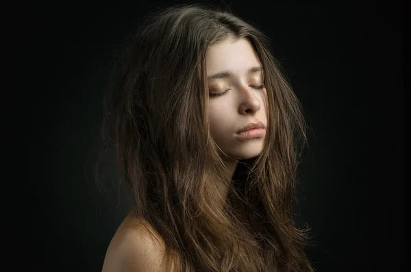 Dramatic portrait of a girl theme: portrait of a beautiful girl on a background in the studio — Stock Photo, Image