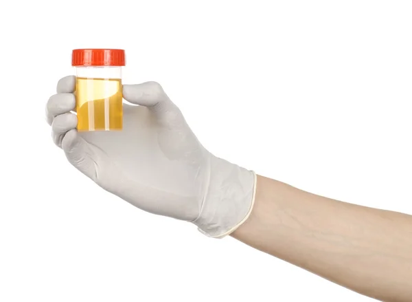 Medical theme: doctor's hand in white gloves holding a transparent container with the analysis of urine on a white background — Stock Photo, Image