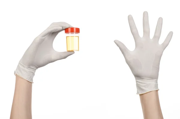 Medical theme: doctor's hand in white gloves holding a transparent container with the analysis of urine on a white background — Stock Photo, Image