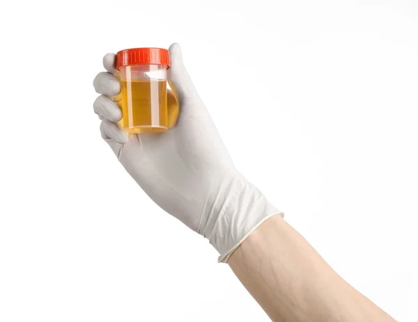 Medical theme: doctor's hand in white gloves holding a transparent container with the analysis of urine on a white background — Stock Photo, Image