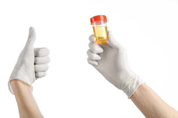 Medical theme: doctor's hand in white gloves holding a transparent container with the analysis of urine on a white background — Stock Photo, Image