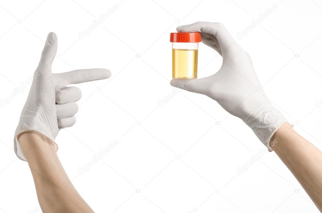 Medical theme: doctor's hand in white gloves holding a transparent container with the analysis of urine on a white background