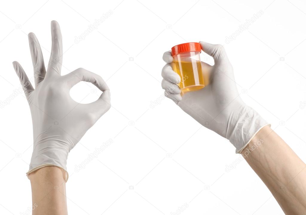 Medical theme: doctor's hand in white gloves holding a transparent container with the analysis of urine on a white background