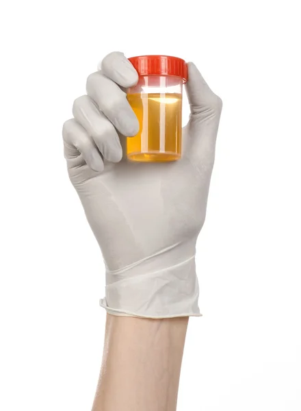 Medical theme: doctor's hand in white gloves holding a transparent container with the analysis of urine on a white background — Stock Photo, Image