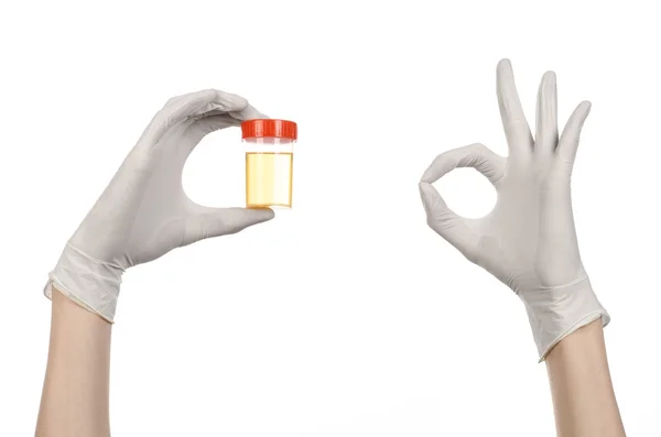 Medical theme: doctor's hand in white gloves holding a transparent container with the analysis of urine on a white background — Stock Photo, Image