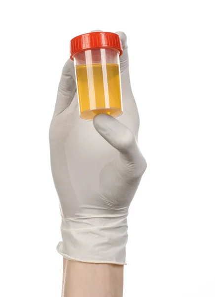 Medical theme: doctor's hand in white gloves holding a transparent container with the analysis of urine on a white background — Stock Photo, Image