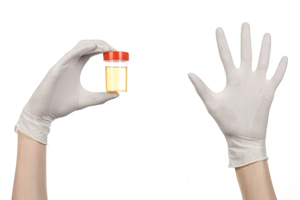 Medical theme: doctor's hand in white gloves holding a transparent container with the analysis of urine on a white background — Stock Photo, Image