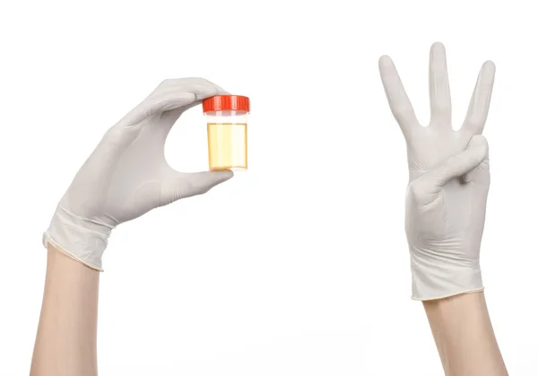 Medical theme: doctor's hand in white gloves holding a transparent container with the analysis of urine on a white background — Stock Photo, Image