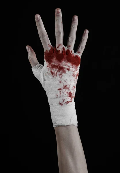 Shook his bloody hand in a bandage, bloody bandage, fight club, street fight, violence, bloody theme, isolated, bloody fists, boxer, tied his hands with a bandage, black background — Stock Photo, Image