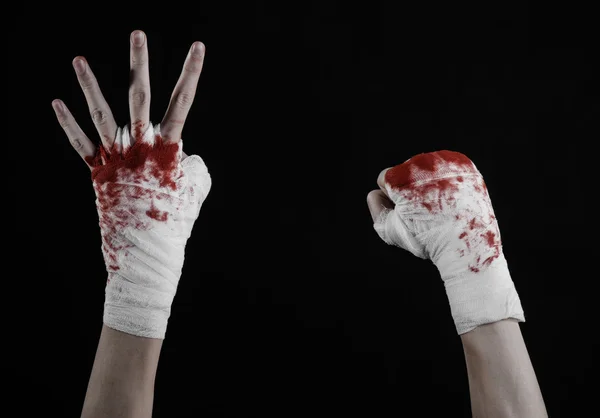 Shook his bloody hand in a bandage, bloody bandage, fight club, street fight, violence, bloody theme, isolated, bloody fists, boxer, tied his hands with a bandage, black background — Stock Photo, Image