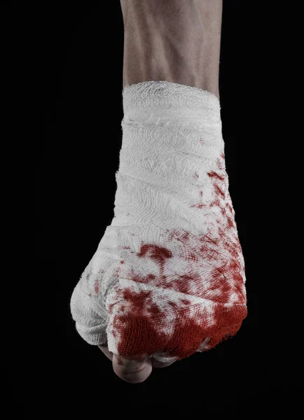 Shook his bloody hand in a bandage, bloody bandage, fight club, street fight, violence, bloody theme, isolated, bloody fists, boxer, tied his hands with a bandage, black background — Stock Photo, Image