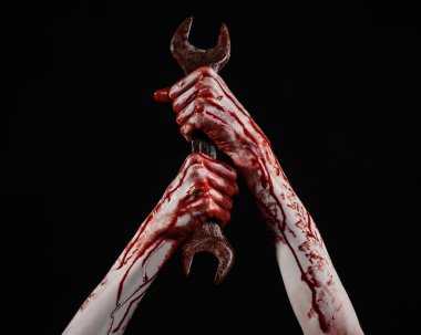 bloody hand holding a big wrench, bloody wrench, big key, bloody theme, halloween theme, crazy mechanic, murderer, psycho, violence, zombies, black background, isolated, revolution