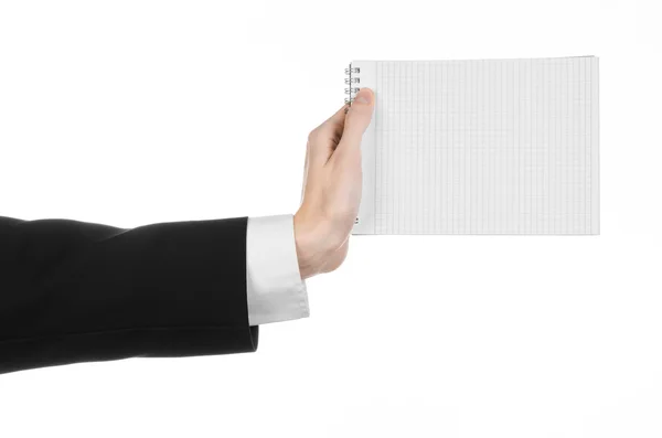 Business and reporter topic: the hand of a journalist in a black suit holding a notebook with a pencil on a white background isolated — Stock Photo, Image