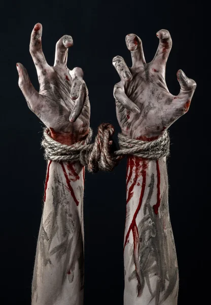 Hands bound,bloody hands, mud, rope, on a black background, isolated, kidnapping, zombie, demon — Stock Photo, Image