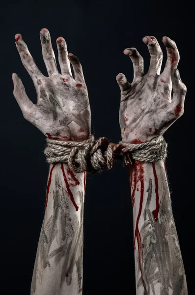 Hands bound,bloody hands, mud, rope, on a black background, isolated, kidnapping, zombie, demon — Stock Photo, Image