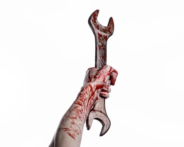 Bloody hand holding a big wrench, bloody wrench, big key, bloody theme, halloween theme, crazy mechanic, murderer, psycho, violence, zombies, white background, isolated, revolution — Stock Photo, Image