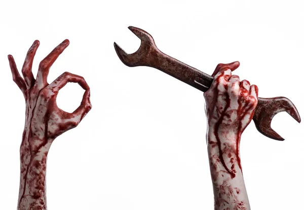 Bloody hand holding a big wrench, bloody wrench, big key, bloody theme, halloween theme, crazy mechanic, murderer, psycho, violence, zombies, white background, isolated, revolution — Stock Photo, Image