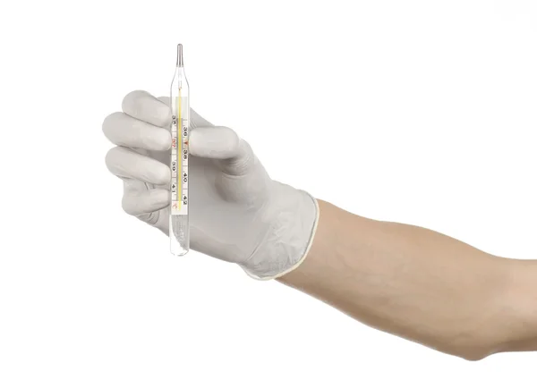 Medizinisches Thema: Arzthand in weißen Handschuhen, die ein Thermometer hält, um die Temperatur des Patienten auf weißem Hintergrund zu messen — Stockfoto