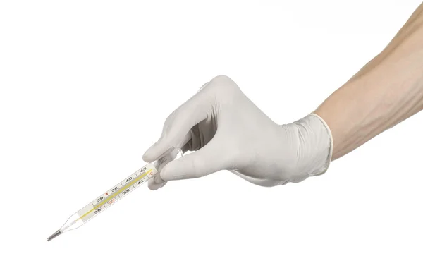 Medical theme: doctor's hand in white gloves holding a thermometer to measure the temperature of the patient on a white background — Stock Photo, Image