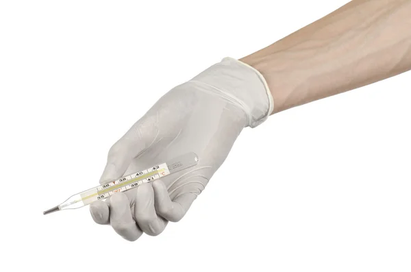 Tema médico: Mano del médico con guantes blancos sosteniendo un termómetro para medir la temperatura del paciente sobre un fondo blanco — Foto de Stock