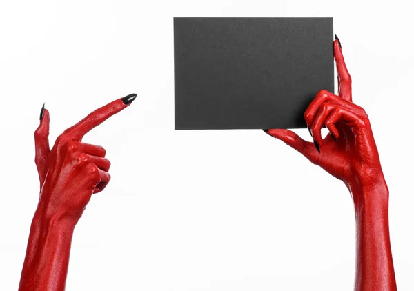 Halloween theme: Red devil hand with black nails holding a blank black card on a white background — Stock Photo, Image