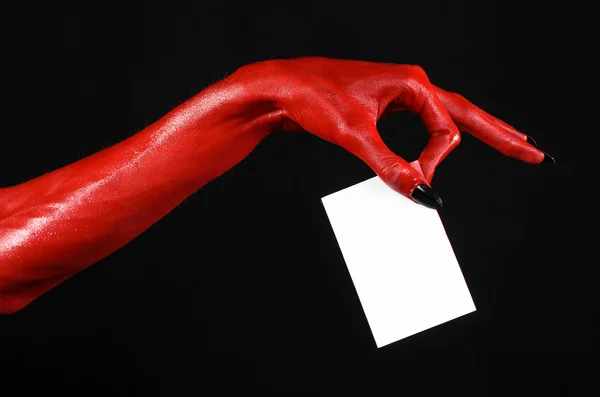 Хэллоуин тема: Красный дьявол рука с черными ногтями держа пустую белую карту на черном фоне — стоковое фото