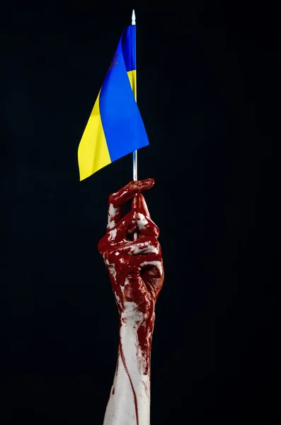 Bloody hands, the flag of Ukraine in the blood, revolution in Ukraine, Black background — Stock Photo, Image