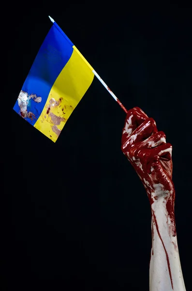 Bloody hands, the flag of Ukraine in the blood, revolution in Ukraine, Black background — Stock Photo, Image