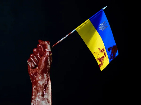 Bloody hands, the flag of Ukraine in the blood, revolution in Ukraine, Black background — Stock Photo, Image