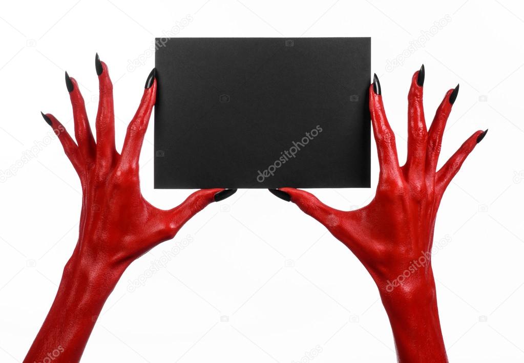 Halloween theme: Red devil hand with black nails holding a blank black card on a white background