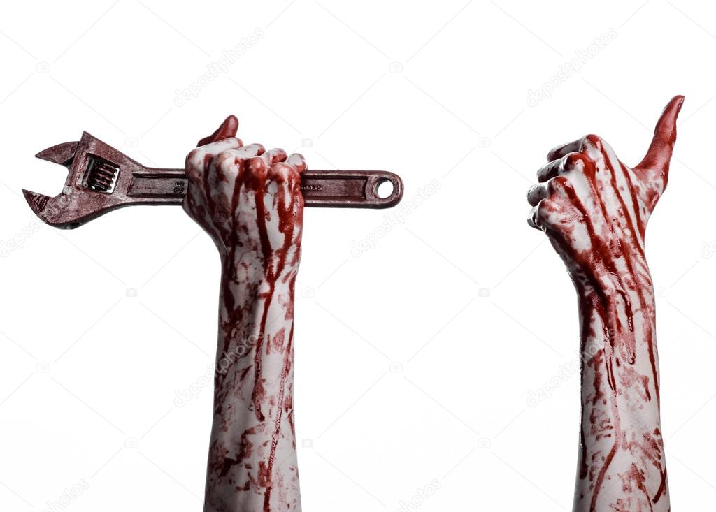 Halloween theme: bloody hand holding a big wrench on a white background