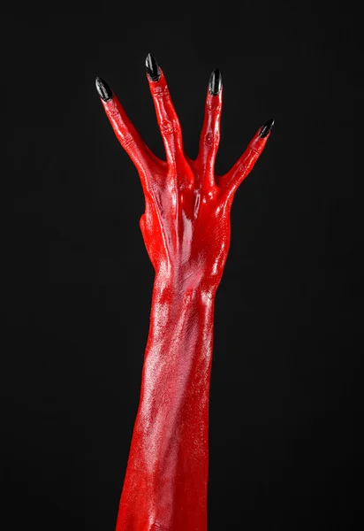 Red Devil's hands, red hands of Satan, Halloween theme, black background, isolated