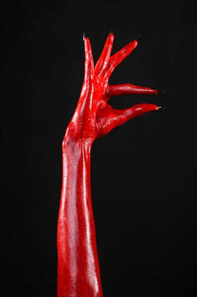 Vörös ördög kezében, vörös kéz a Sátán, Halloween témát, a fekete háttér, elszigetelt — Stock Fotó