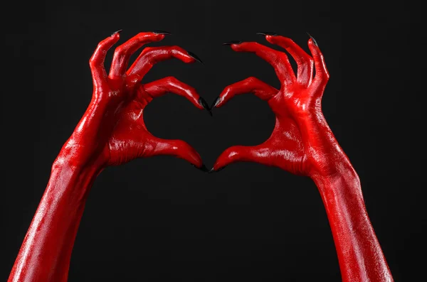Rote Hände des Teufels, rote Hände satans, Halloween-Thema, schwarzer Hintergrund, isoliertes Herz — Stockfoto