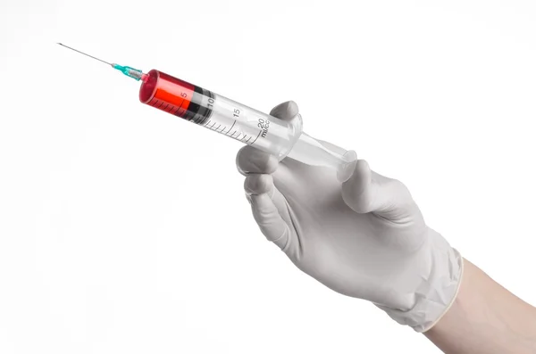 Doctor's hand holding a syringe, white-gloved hand, a large syringe, medical issue, the doctor makes an injection, white background, isolated, white gloves doctor, ebola test, red medication — Stock Photo, Image