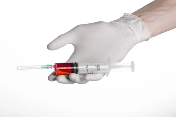Doctor's hand holding a syringe, white-gloved hand, a large syringe, medical issue, the doctor makes an injection, white background, isolated, white gloves doctor, ebola test, red medication — Stock Photo, Image