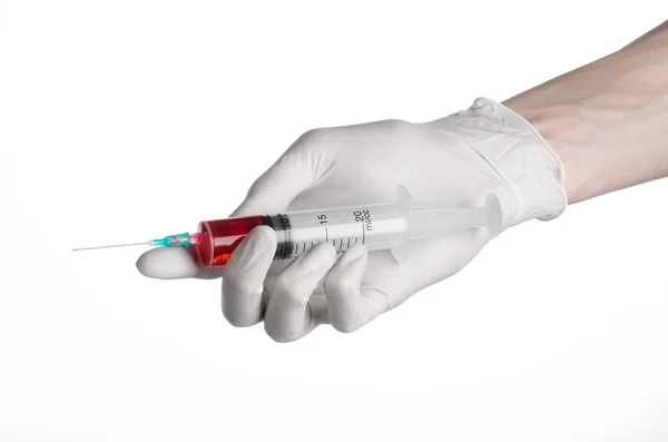 Doctor's hand holding a syringe, white-gloved hand, a large syringe, medical issue, the doctor makes an injection, white background, isolated, white gloves doctor, ebola test, red medication — Stock Photo, Image