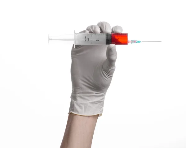 Doctor's hand holding a syringe, white-gloved hand, a large syringe, medical issue, the doctor makes an injection, white background, isolated, white gloves doctor, ebola test, red medication — Stock Photo, Image