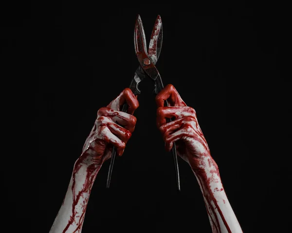 Halloween theme: bloody hand holding a big old bloody scissors on a black background — Stock Photo, Image