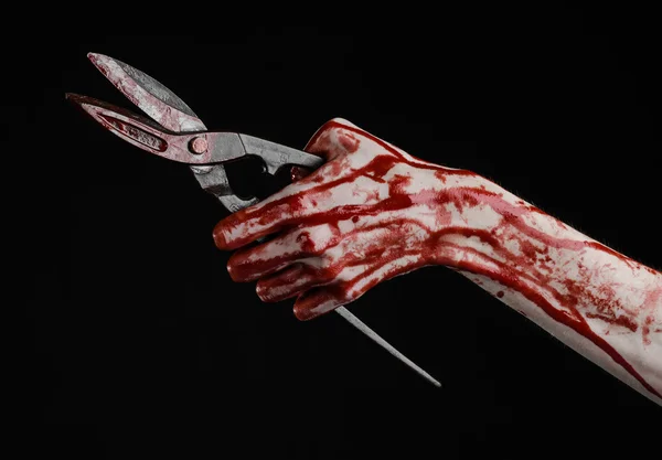 Halloween theme: bloody hand holding a big old bloody scissors on a black background — Stock Photo, Image